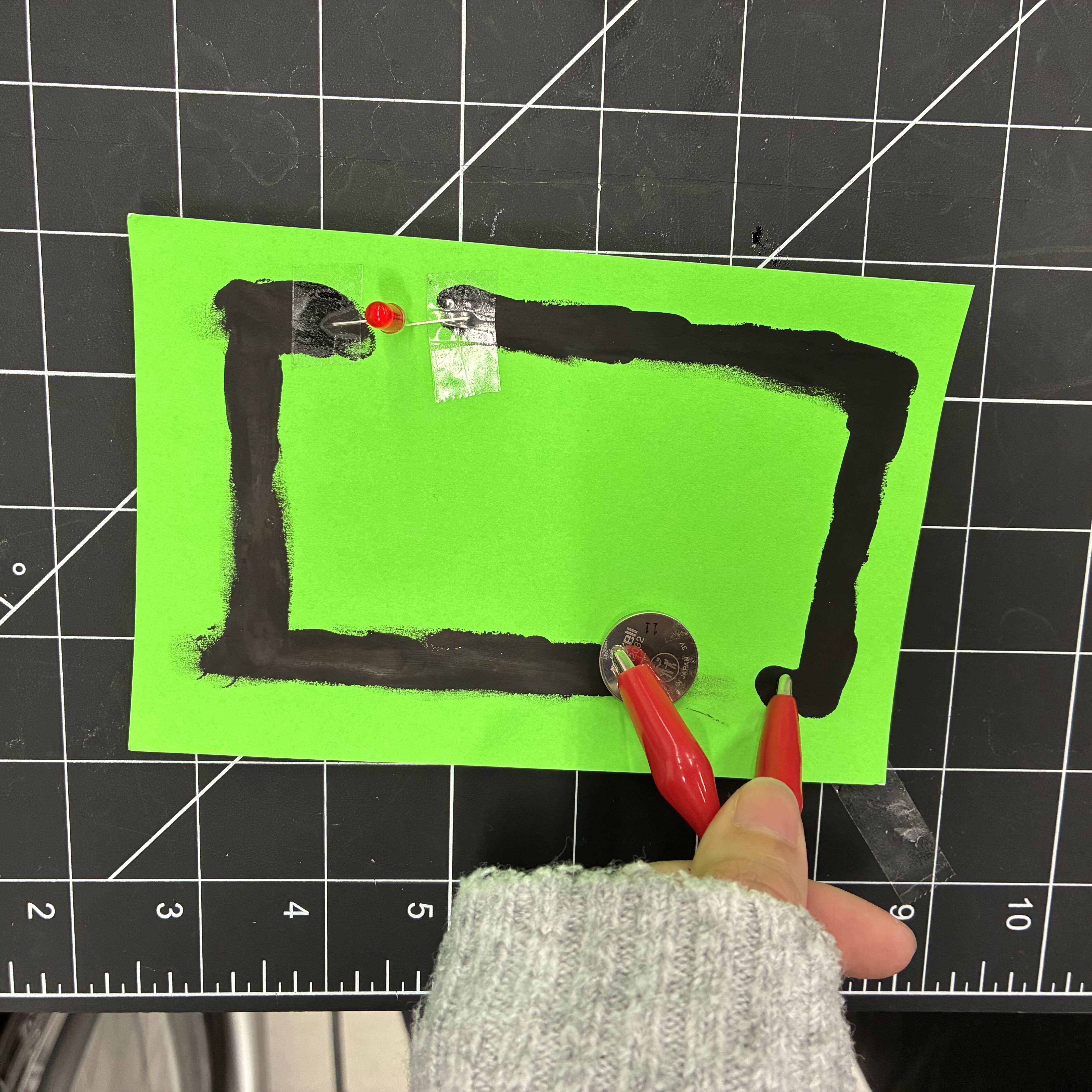 This is the rectangle made of conductive paint at a slightly different angle to exemplify the glowing light and how the LED light is secured to the conductive paint.