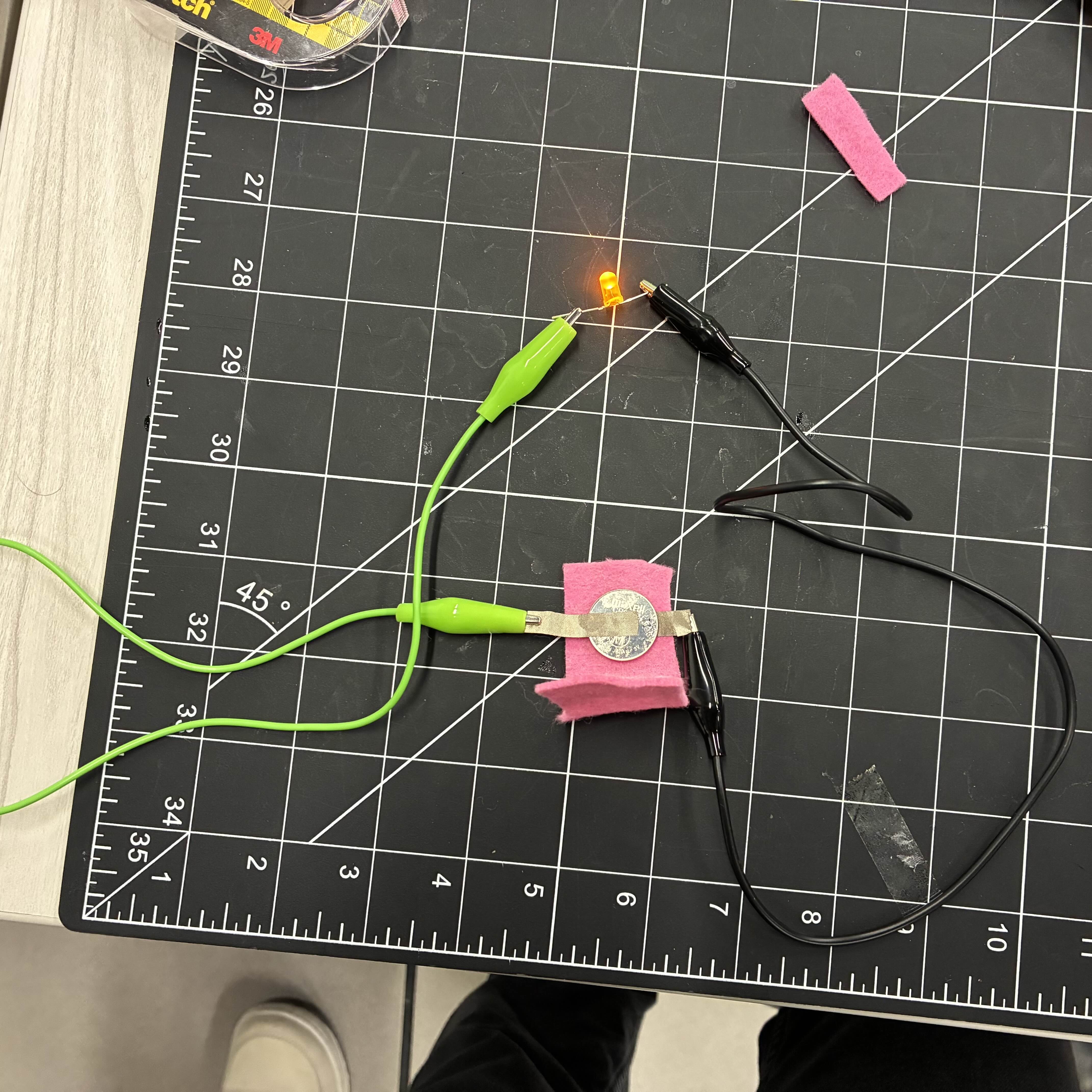 This is my smaller battery pocket before I fully finished it. I wanted to see if the conductive fabric worked so I tried it before sealing the pocket. I used alligator clip wires to connect the fabric to the LED light.