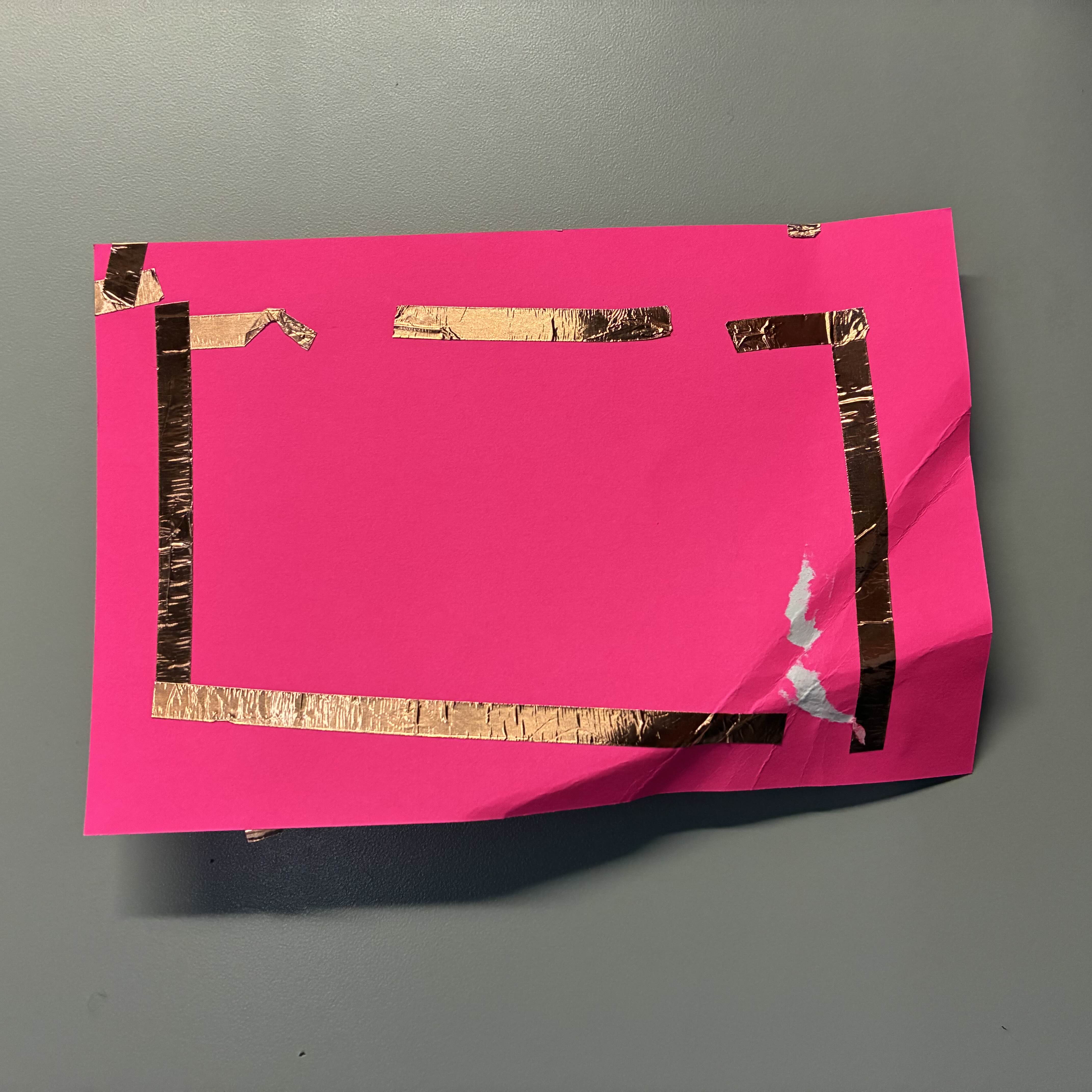 This was my failed attempt at a series circuit. I didn't line up the fold properly so the copper tape couldn't touch the battery at the same time. I also accidently ripped the tape while trying to secure the LED lights in place.