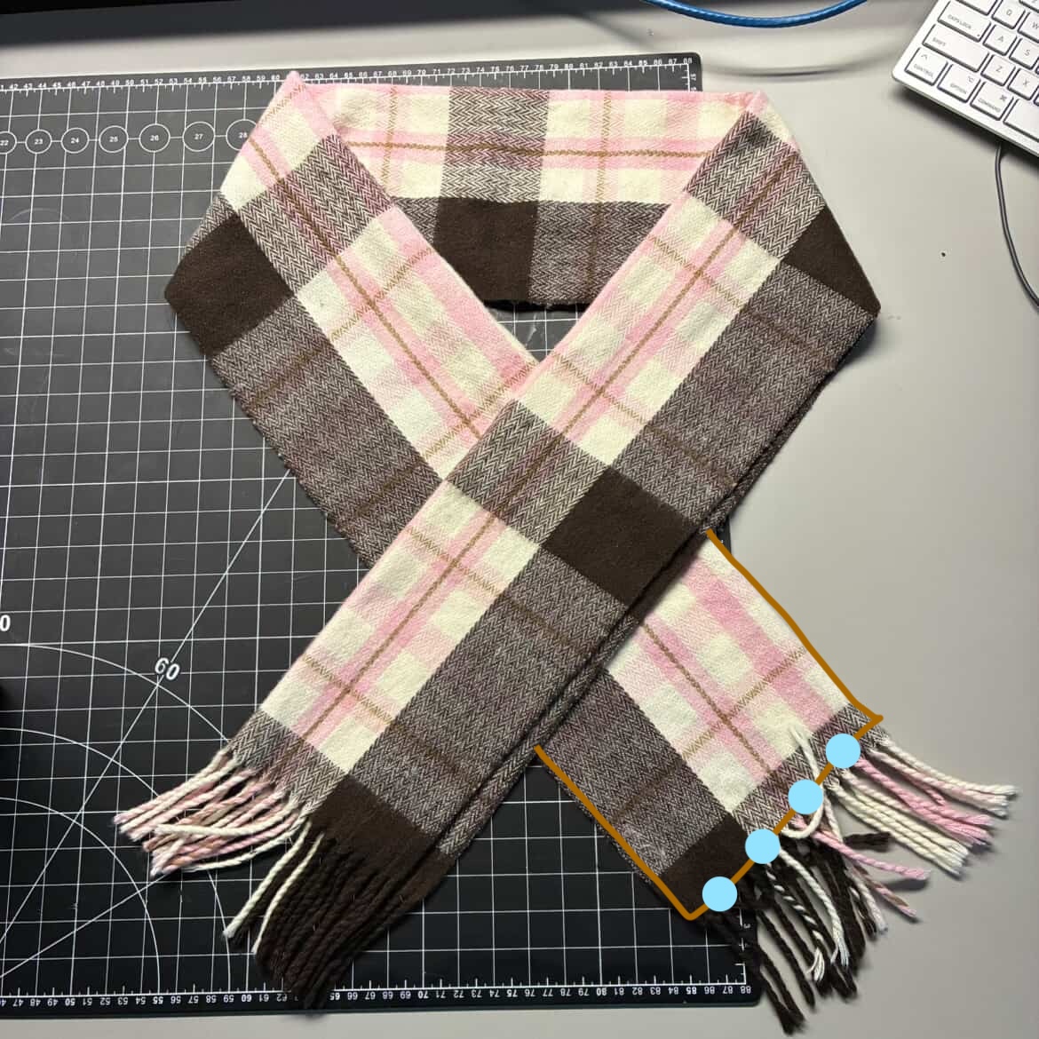 When the scarf is put on top of itself the battery connects the two sides and makes the LED lights turn on. Realistically, I would have to use more than one battery to power this many lights.