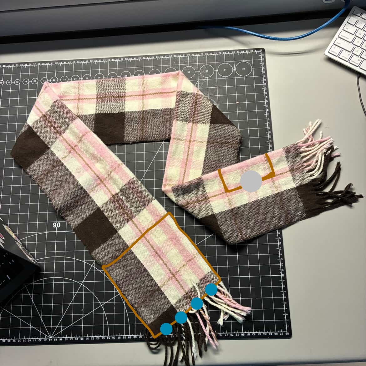 This is my scarf and I chose it so I would have a wearable item to include in this activity. There is copper tape on both sides of the scarf, one side has the battery and the other side has a line of four LED lights. There is supposed to be an opening at the top of the tape that is connected to the lights for the battery. 