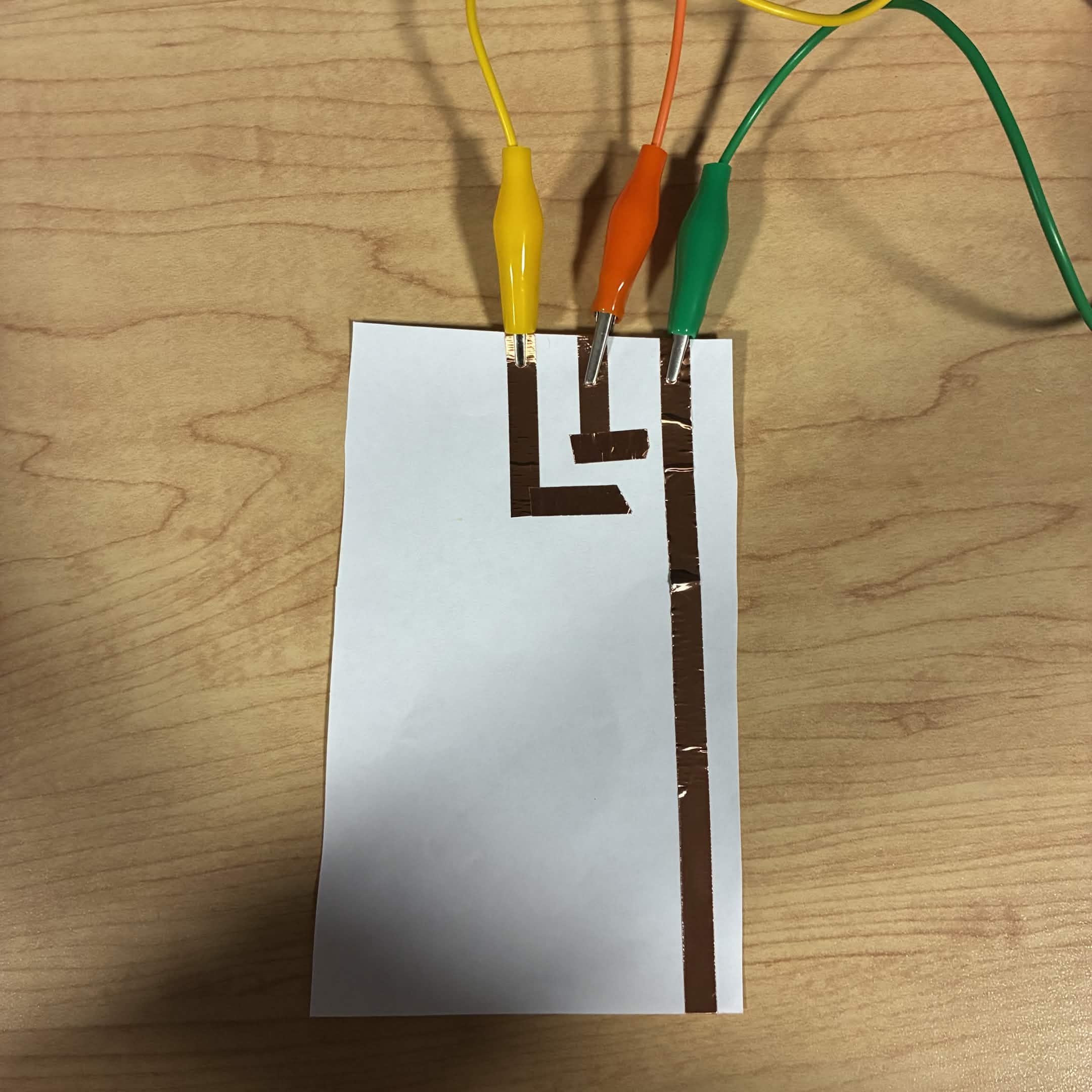 I started to add more circuits and connect them to different buttons on the Makey Makey.The yellow wire is connected to the down button, the orange wire is connected to the left button, and green is connected to ground.
